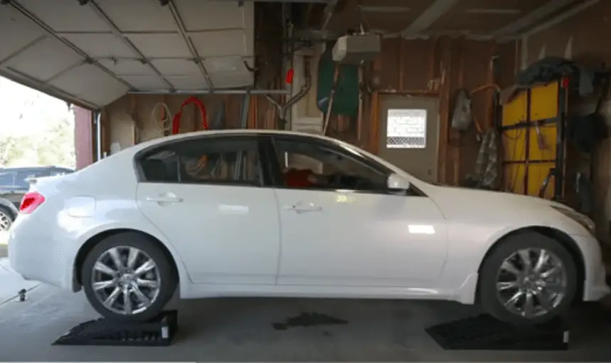 lifting the car on ramps for changing oil