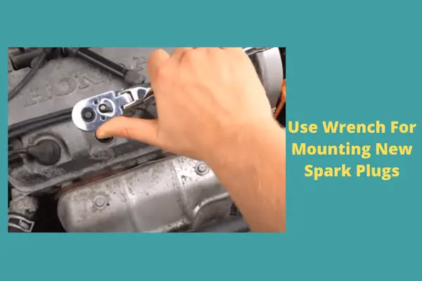 use wrench for mounting new spark plugs 